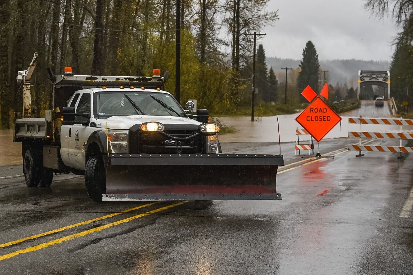 A Lewis County Public Works truck drives along Cispus Road in Randle near a road closure on Friday.